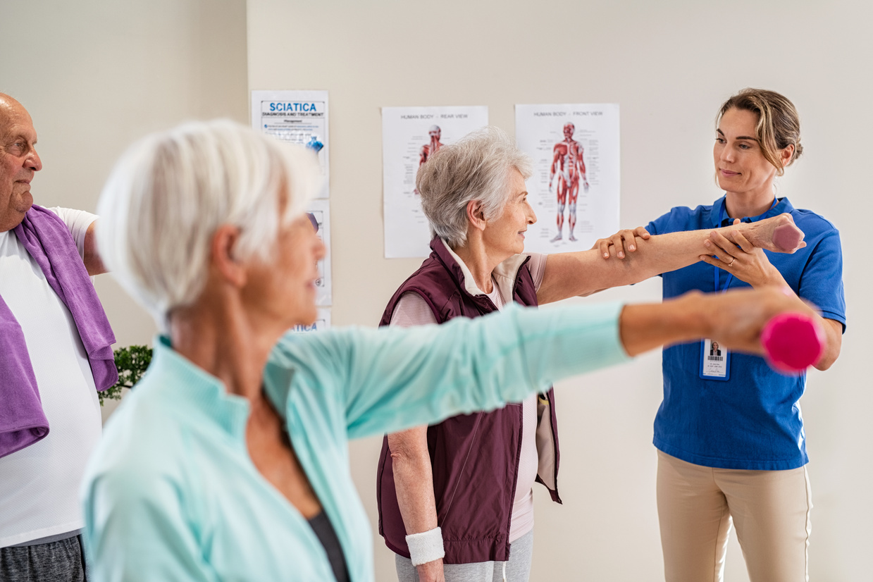Physiotherapist Helping Seniors Exercise