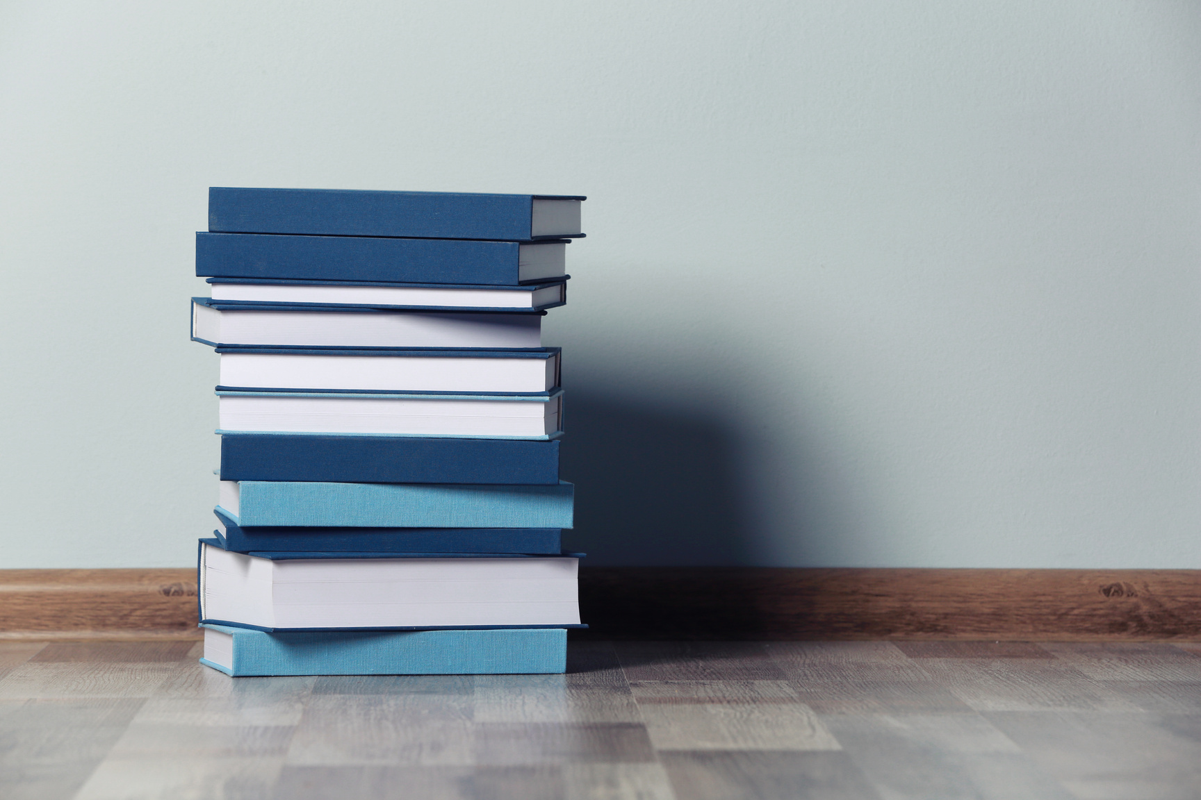 Stack of Blue Books on the Floor 