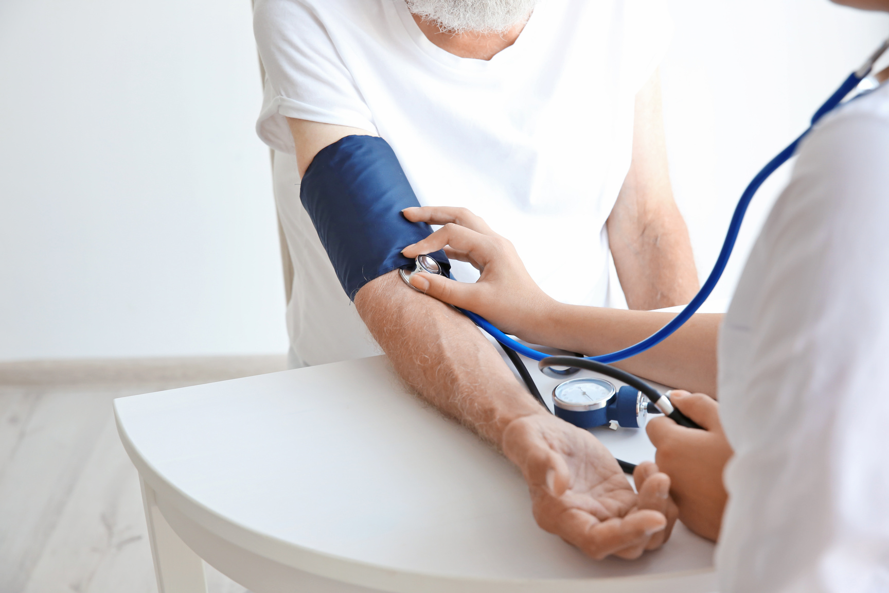 Nurse Measuring Blood Pressure of an Elderly Man Up Close